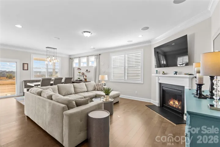 Open family room and dining area, lots of natural light, plantation shutters, 5" engineered flooring and gas fireplace