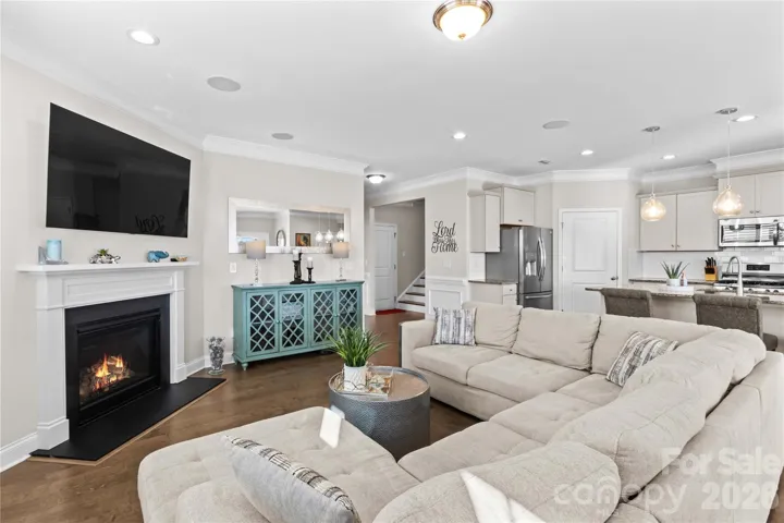 Open family room to kitchen and dining area with 5" engineered flooring