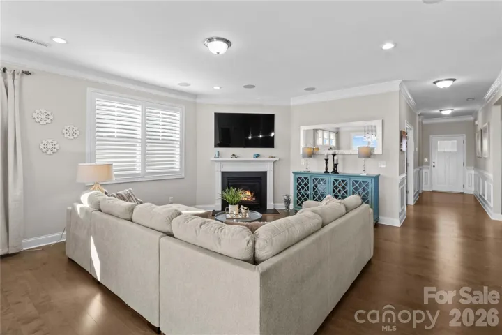 Family Room with gas fireplace, TV mount, lots of natural light, recessed lighting, built in surround sound and plantation shutters