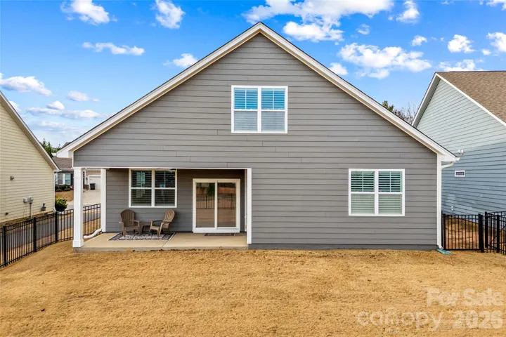 Rear house with covered patio and fenced yard
