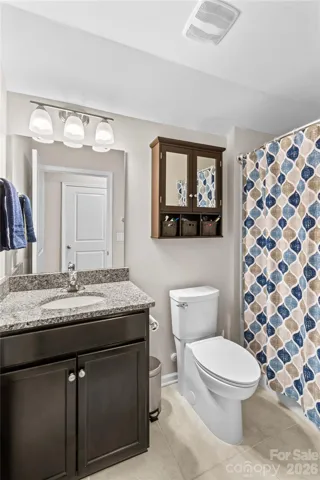 Upper Level bath, confort height toilet and tile flooring
