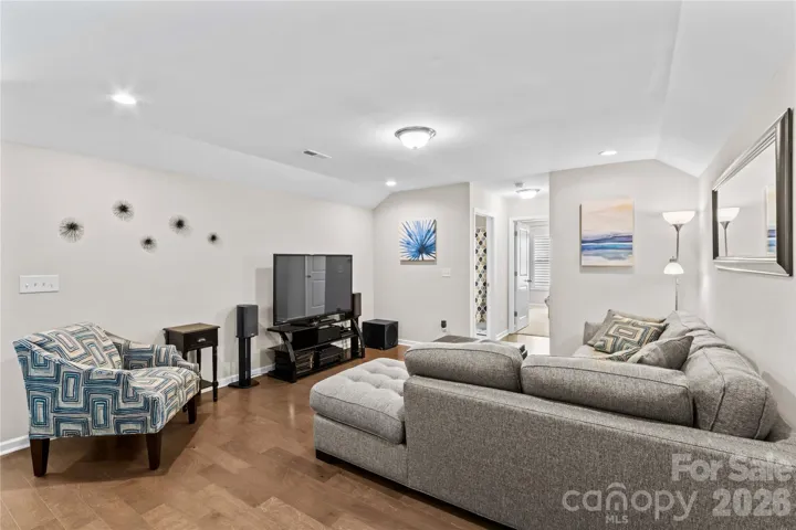 Loft with recessed lighting, lots of options (playroom, tv/game room) and engineered flooring