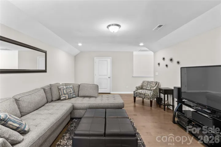 Loft area with access to storage closet and walk in attic