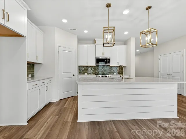 42" cabinets with soft close doors & drawers, Quartz countertops, tile backsplash, Frigidaire gallery appliances. Shiplap accent Island. Cooking exhaust vented to the outside