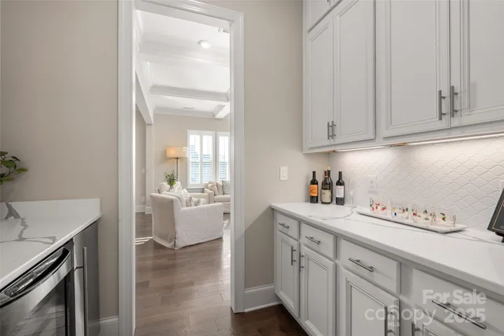 Butlers pantry connects the formal dining room to the kitchen - Features wine fridge and ice maker