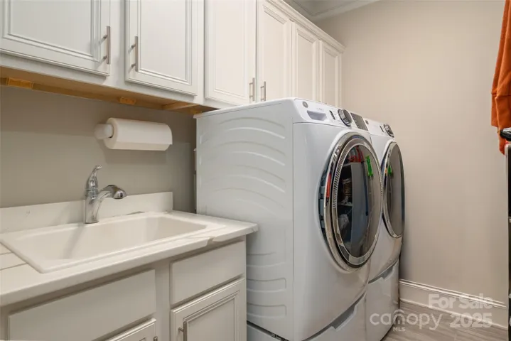 Laundry upgraded with cabinetry is located on upper level and has direct access to primary bath