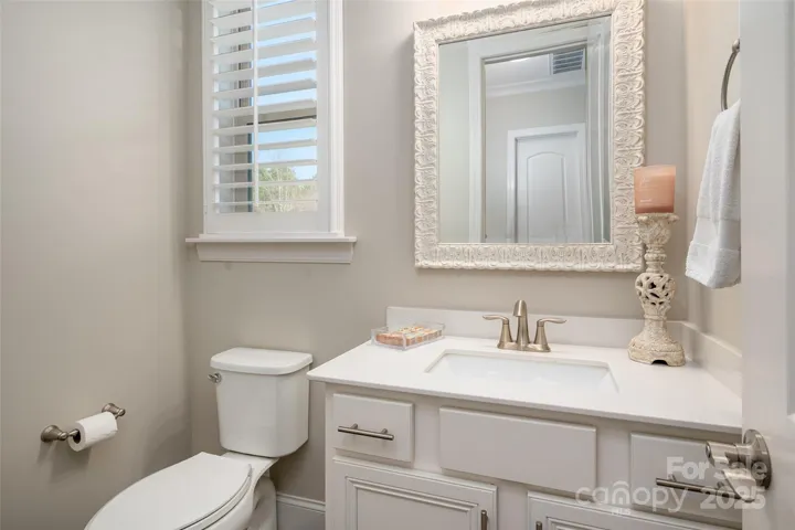 Powder bath conveniently located near kitchen and rear entry