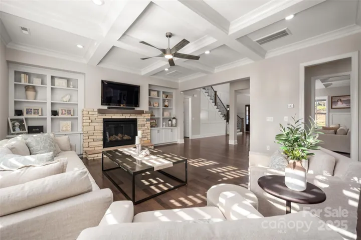 Additional features include crown molding and coiffured ceiling