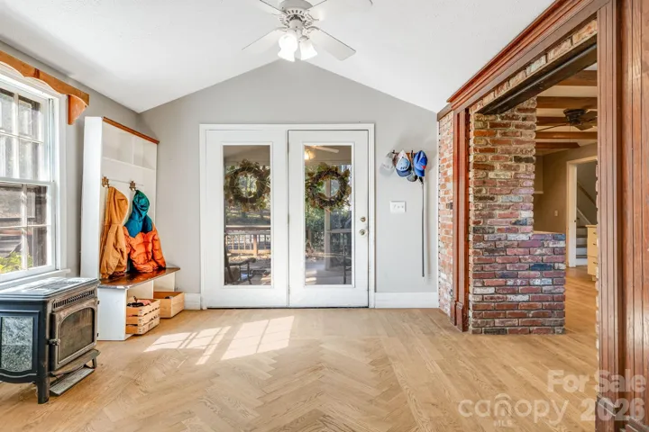 Custom herringbone hardwood floor entry, bright interior