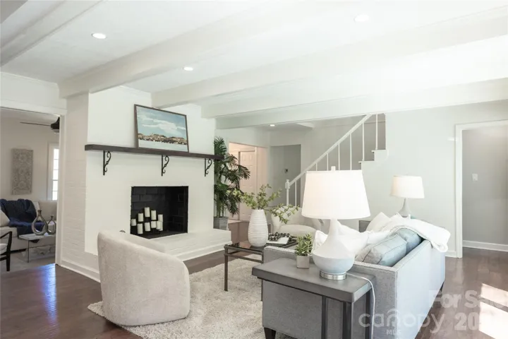 This picture shows your living room off to the left, your family room in the center looking into your entry way to the 3 bedrooms & 2 full bathrooms, to the left of your stairs to your upper level balcony, and far right doorway to your lower level living!