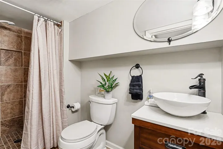 Lower level  full bathroom with easy walk-in tiled stall shower.