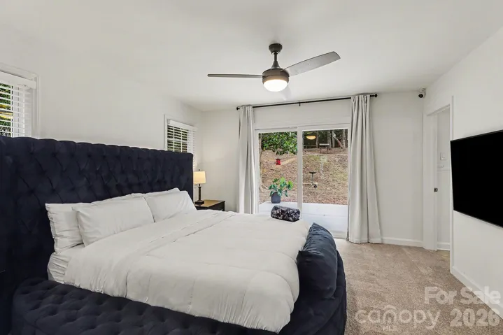 Primary BR features lush carpeting, 2 walk-in closets, en-suite bathroom and sliders to the backyard.