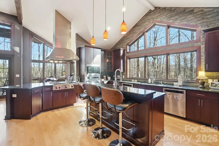 Kitchen with WOLF gas range, island and amazing natural light.