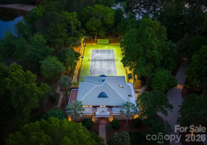 Guest house and tennis court at twilight. 
