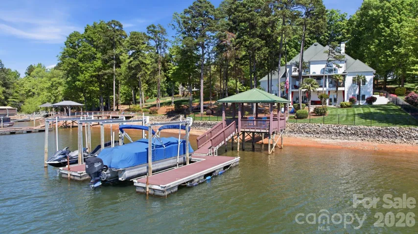 Dock with covered lounge area and two boat lifts. 