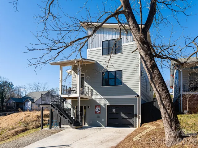 Front of Home with additional gravel parking area.