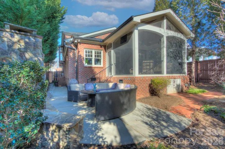 Garden view highlighting the screened porch addition and peaceful backyard setting.