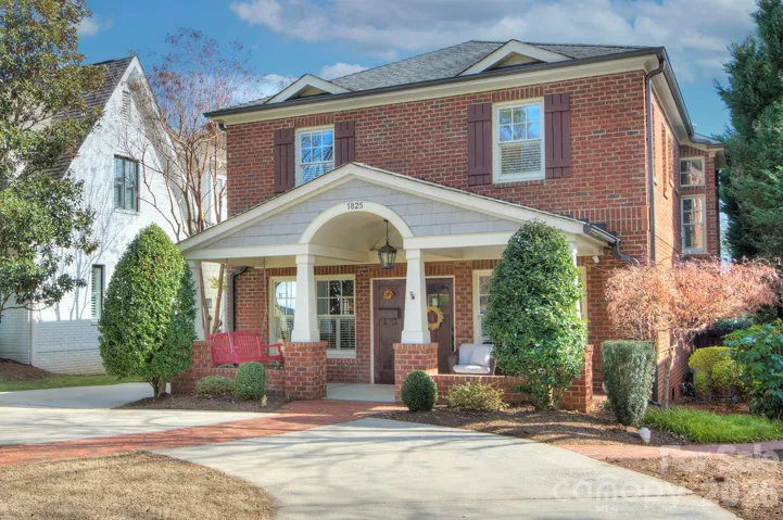 Classic full-brick exterior with inviting front porch and circular drive, perfectly positioned on one of Dilworth’s premier streets.