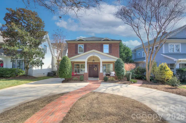Charming front elevation highlighting manicured landscaping and the home’s timeless architectural appeal.