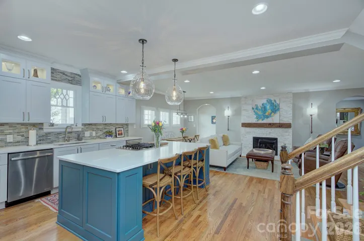 Open-concept kitchen showcasing a large island, custom cabinetry, and easy flow into the living space.