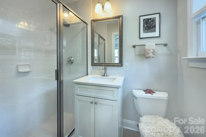 The adjoining bath includes a dual vanity and tub/shower combination, ideal for family or guests.