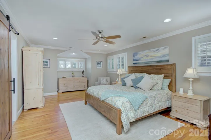 The spacious (second level) primary suite offers hardwood floors, generous layout options, and abundant natural light for a relaxing retreat.
