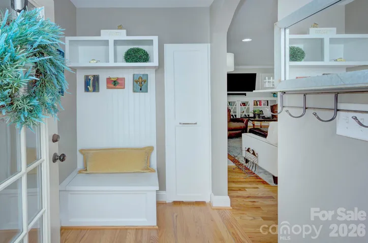 A welcoming drop zone features built-in bench seating, cubbies and hooks, creating an organized and stylish everyday entry space.