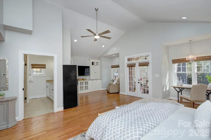 View of main level primary suite showcasing generous space, built-in storage, and easy access to the kitchenette and the en-suite bath.