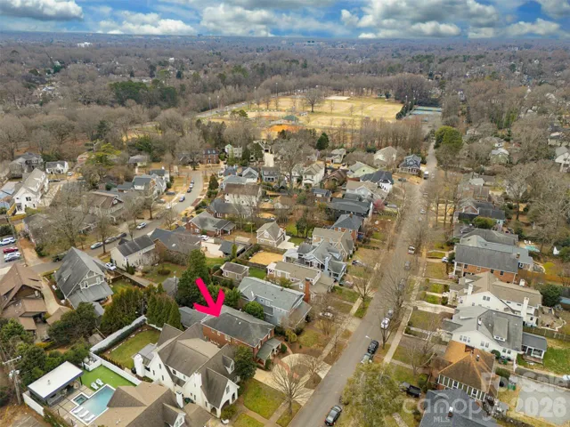 Aerial perspective emphasizing the home’s charming curb appeal among mature neighborhood trees as well as the proximity to Freedom Park.