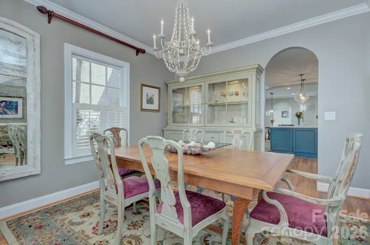 Alternate view of the dining room highlights the charming vintage finishes and seamless flow toward the kitchen.