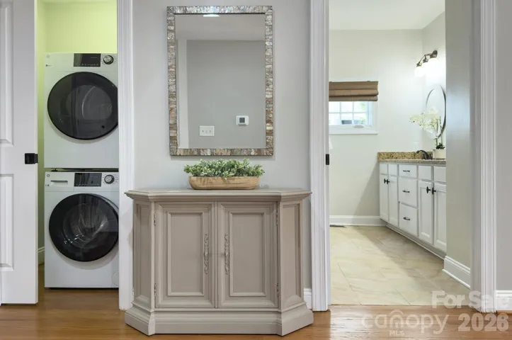 Convenient laundry area and additional storage located on the main level in the primary suite for everyday ease.