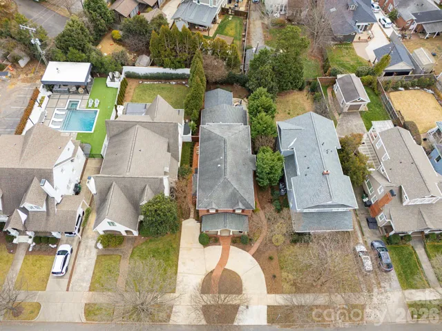 Elevated front view highlighting the home’s classic brick exterior and rare circular driveway in this community.