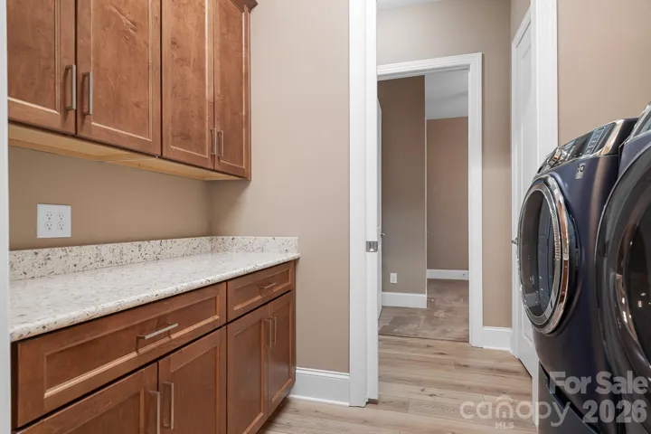 laundry area/ walk through into primary bathroom with lots of extra storage
