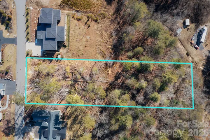 Gentle 0.93-acre lot with short-range views of the craggy mountains in the highly sought-after Riverbend Forest community.