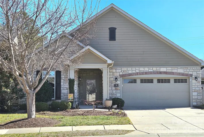 Front of home. Covered front porch entry. Beautiful stone accents.