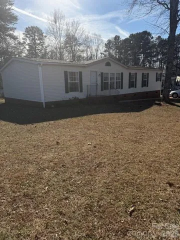 Spacious Mobile Home -Front White vinyl-   Green Shutters on .47 acres