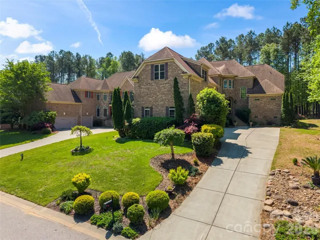Full-brick custom built home surrounded by mature landscaping