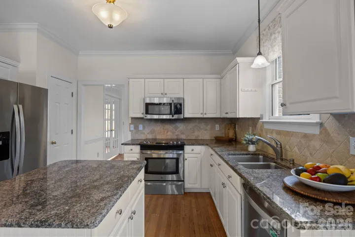 This is a beautifully appointed kitchen designed for both functionality and seamless entertaining.