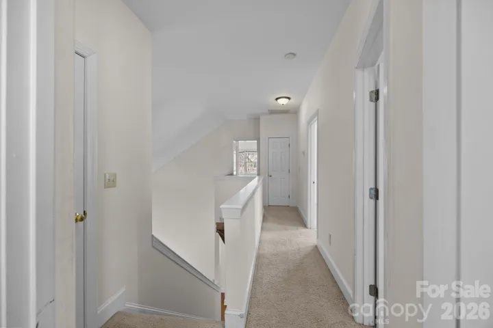 This home features an impressive long stairway that serves as a central vertical element that culminates on the second level, opening directly into the upstairs hall, which is the central access point to the private bedrooms and other second-floor spaces.