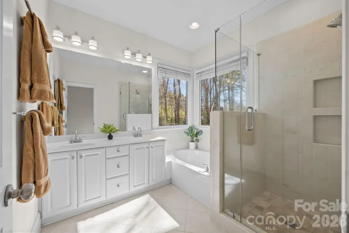 This luxurious en suite is a spacious, spa-like retreat designed for ultimate comfort and functionality.