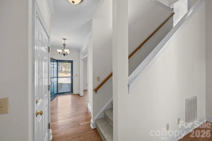 This elegant space is bathed in natural light, thanks to a perfectly positioned window and serves as a sophisticated introduction to the home's interior, blending classic charm with bright, inviting appeal.