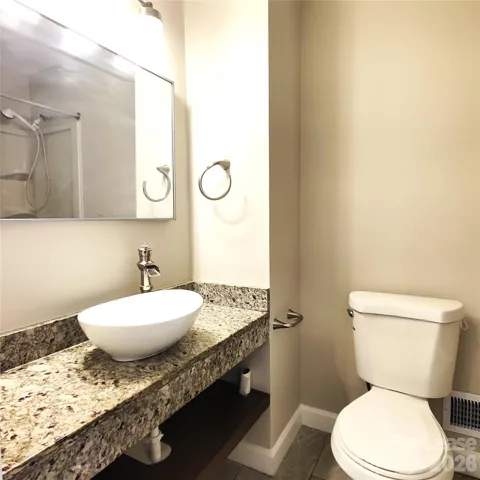 Hall bathroom has cute above-counter sink with lots of counter space!