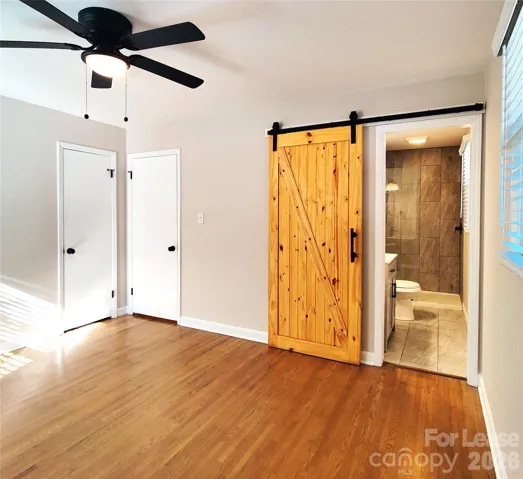 Primary bedroom has private bathroom with pretty barn door!