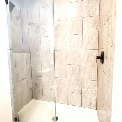 Walk-in shower has tile surround!