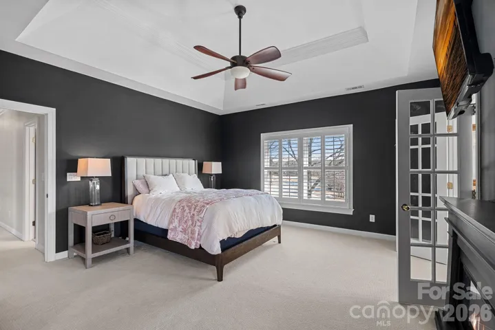 Primary Suite with Tray Ceiling, sitting room, large walk in closet, and Ensuite bath.