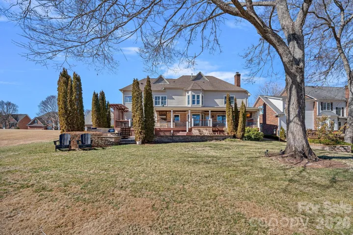 View of the back of the home and the backyard.  Common area is to the left in this picture.