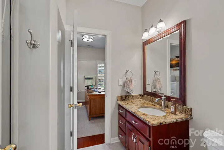 Full bath with custom cabinetry, granite countertop vanity and adjacent to bedroom number 4.