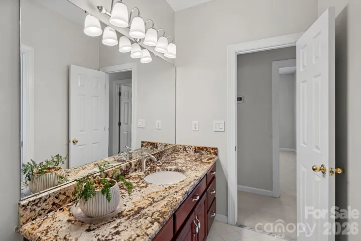 Full bath upstairs across from another bedroom with beautiful granite vanity top.