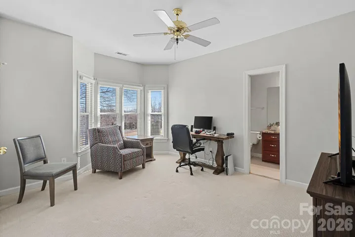 Bedroom number 2 with bay window overlooking the golf course and adjacent to a full bath.