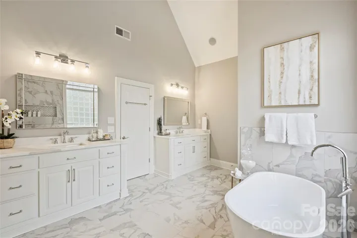 Primary bathroom renovated in 2026 with Brazilian Bianco Rhino natural stone countertops